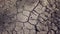 Dry gray ground cracked texture, horizontal natural background top view. Closeup shot