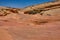 Dry gully in the Nevada desert surrounded by the colorful pink lined rocks