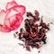 Dry hibiscus tea and a lively pink rose