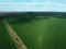 A dry irrigation canal in a sown field, aerial view. Farmland landscape