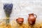 Dry laveder bouquet and pottery jars on rustic background top view mockup