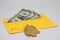 Dry leaf. banknotes in a yellow envelope. open envelope with banknotes on a light background. envelope with banknotes