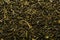 Dry leaves of green tea background texture, heap of dried leaves Chinese green teas with primiems