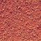 Dry light red crushed bricks surface on outdoor tennis ground. Detail of texture