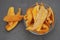 Dry Mango Fruit Chips Heap Glass Bowl on Gray Background. Top view. Healthy Snack.