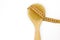 Dry massage eco natural anti cellulite brush with yellow centimeter on white background. Body care home spa. Fitness summer time