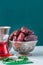 Dry medjoul dates in a vintage bowl with turkish tea in a glass