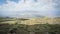 Dry mountainous landscape with small settlement and mountain ranges in backdrop, Mount Ararat