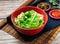 Dry noodles with green onion and chili sauce served in a bowl isolated on table top view of taiwanese food