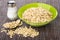 Dry oatmeal in bowl, salt, spoon, scattered oatmeal on mat