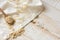 Dry oatmeal flakes on a wooen spoon over a white linen, cloth, health concept, beauty, skin care