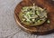 Dry olive Bay leaves in a copper plate on a wooden Board