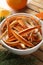 Dry orange peels, oranges and fir branch on white table, closeup