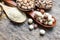 Dry organic lotus seed pile on wooden spoon and grunge background with blur chick pea, pinto, and white sesame
