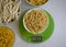 Dry pasta, kitchen scales dieting  on a light background