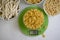 Dry pasta, kitchen scales on a light background