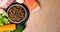 Dry pet dog food with natural ingredients. Raw meat, fish, vegetables, eggs and salad near bowl with dry pet feed on wooden