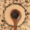 Dry Puer tea leaves in a wooden spoon on a beige background,hard light