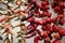 Dry red peppers strung on threads in a display case on the market.