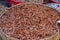 Dry red shrimps or prawns stored in a basket for sell in a market stall