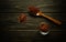 Dry red spices in a wooden spoon and on a vintage table before adding to food for flavor. Fragrant food cooking concept