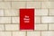 Dry riser inlet box red on brick wall for emergency fire services water connection for hose brigade engine at shopping mall retail