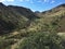 A dry riverbed cuts through rolling hills in Tonto National Monument