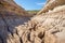 dry riverbed in a deep canyon with cracked soil due to drought