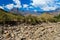 Dry riverbed with mountains in the background