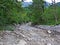 Dry riverbed of seasonal alpine torrential stream above the Rhine river valley Rheintal - Schaan, Liechtenstein