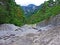 Dry riverbed of seasonal alpine torrential stream above the Rhine river valley Rheintal - Schaan, Liechtenstein