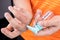 Dry skin finger with bottle of hand sanitizer. Sanitizer causes dryness with frequent use