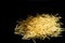 Dry spaghetti stands on a black background. Cooking concept. Space for text