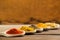 Dry spices on wooden mixing spoons at the table