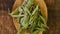 Dry stevia leaves in a wooden spoon close-up on a wooden background. Stevia rebaudiana.Organic natural sweetener.