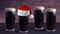 Dry stout beer dark pints with a Holiday santa hat