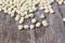 Dry sugar pea seed, green nuts on the wood board background