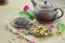 Dry tea in brown plate on wooden background