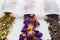 Dry tea in filter teabag sachet on bright background. Organic Crocus flowers, lavender, lemongrass closeup.