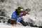 Dry tooling, training. Man in sportswear climbs on a wall using an ice axe