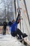 Dry tooling, training. Man in sportswear climbs on a wall using ice axes