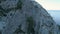 Dry trees on ledges of rocks. Shot. Rare dry trees and shrubs on ledges of rock massifs on background of blue sky