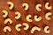 Dry uncooked cavatappi italian pasta, close up on brown wood background.