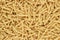 Dry uncooked gemelli pasta texture background