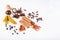 Dry warming Indian spices for autumn and winter meal on white concrete background