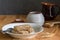Dry wheat cereal bars  in breakfast plate on wooden table with wheat ears in foreground and honey and milk jar in background