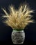 Dry wheat ears and barley spikes in the ceramic vase.