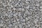 Dry white limestone ballast flat full frame background. Small gray dusty broken macadam stones texture.