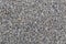 Dry white limestone ballast flat full frame background. Small gray dusty broken macadam stones texture.