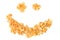 Dry yellow fresh breakfast cereal cornflakes in smile on white b